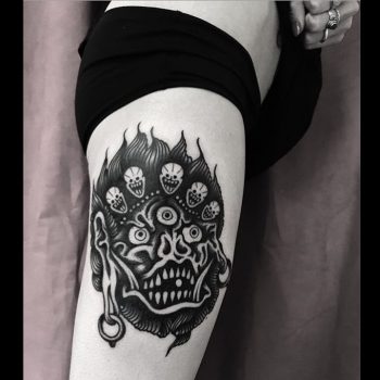 Black devil tattoo on the tricep