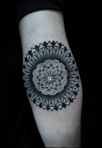 Black dot work mandala arm tattoo