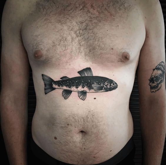 Black fish tattoo on the belly