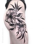 Black flower tattoo on the right hip and thigh