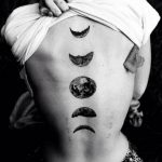 Black moon phases tattoo on the back