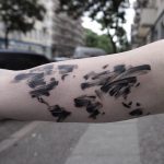 Black paint brush world map tattoo