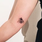 Black small bee tattoo
