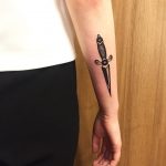 Black small dagger tattoo