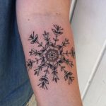 Black snowflake tattoo