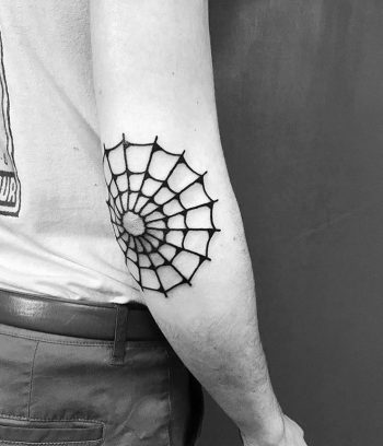 Black spider web tattoo on the elbow