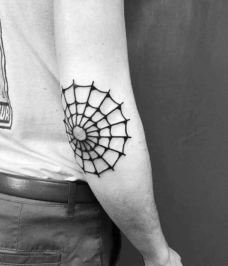 Black spider web tattoo on the elbow