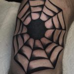 Black spider web tattoo on the knee