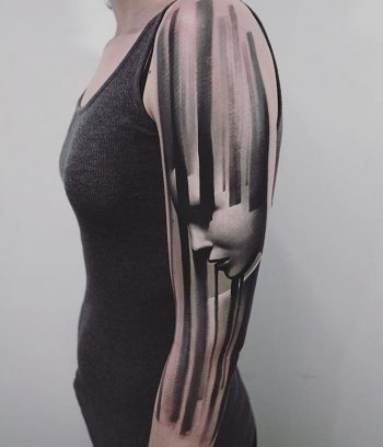 Black stripes and face tattoo on the sleeve