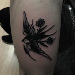 Black swallow and roses tattoo