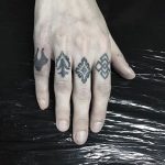 Black tattoos on fingers