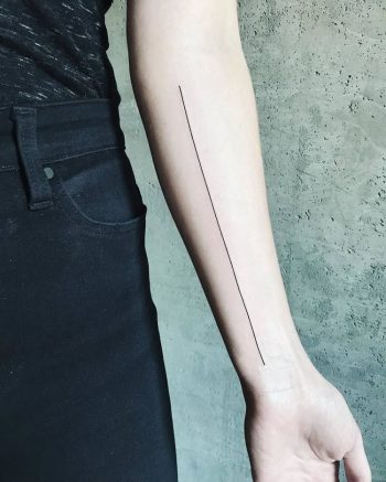 Black thin long line tattoo on the arm