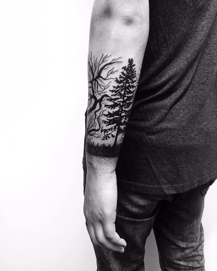 Black tree tattoo on the forearm