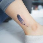 Blue feather tattoo on the ankle
