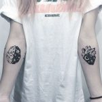 Brain and heart tattoos on arms