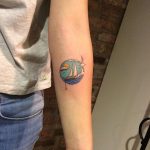 Circular ship in a sea tattoo