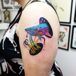 Colorful whale head tattoo on the left arm