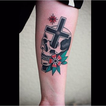 Cross stabbed skull tattoo