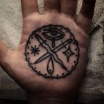Crossed swords tattoo on palm