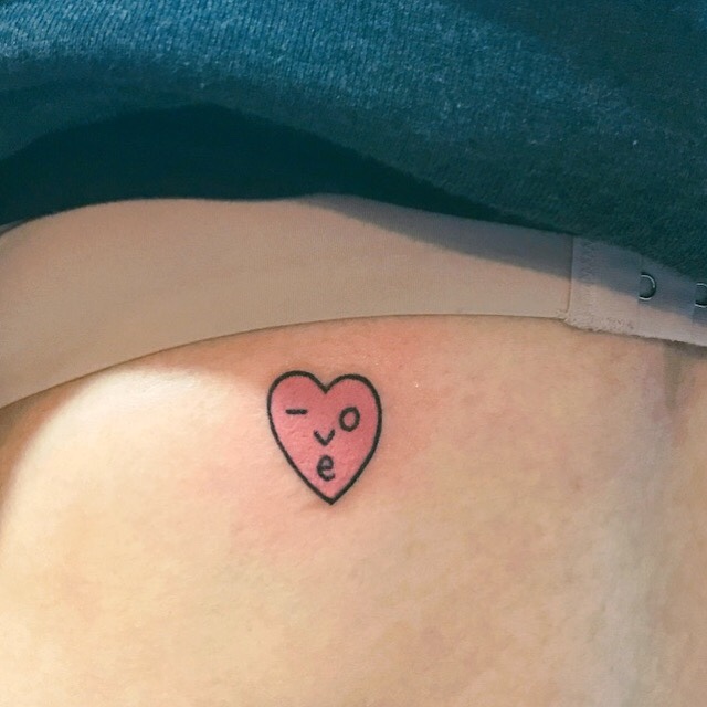 Cute tiny smiley pink heart tattoo