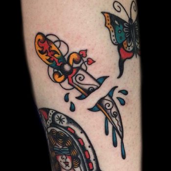 Dagger stabbed leg tattoo