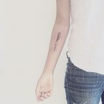 Delicate arrow tattoo on the arm