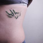 Delicate botanical tattoo on the rib