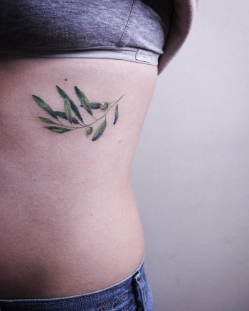 Delicate botanical tattoo on the rib