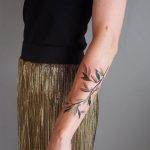 Delicate branch tattoo on the forearm