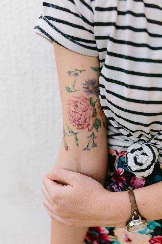 Delicate flowers tattoo on the arm