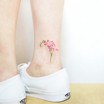 Delicate pink flower tattoo