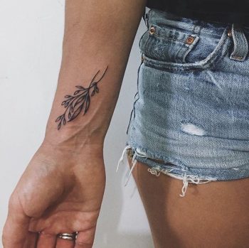Delicate small twigs tattoo