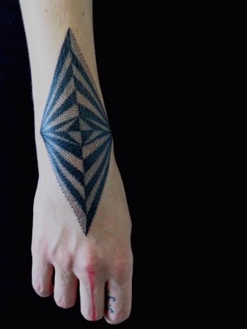 Dot work style geometric pattern tattoo