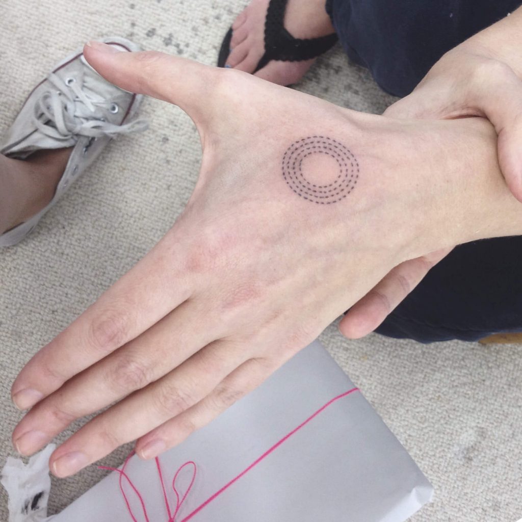 Dotted circle tattoo on the hand