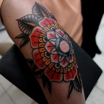 Elbow tattoo of a traditional mandala