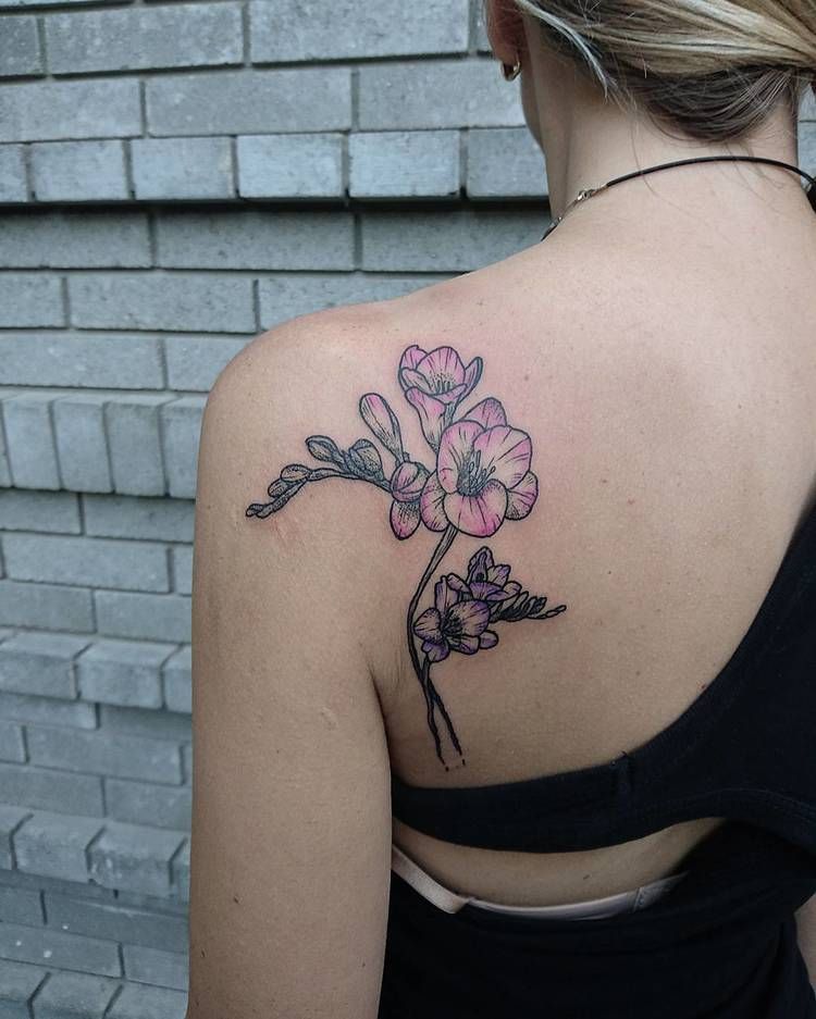 Flower tattoo on the left shoulder blade