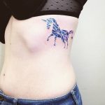 Geometric watercolor unicorn tattoo