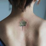 Green tree tattoo on the back