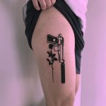 Gun and rose tattoo