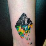 Half realistic half geometric mountain tattoo