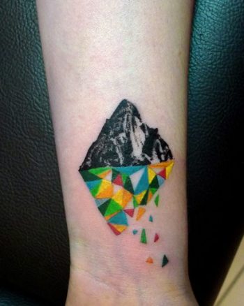 Half realistic half geometric mountain tattoo