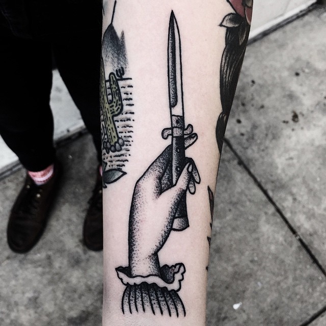 Hand and dagger tattoo