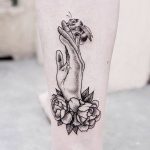 Hand and flower tattoo