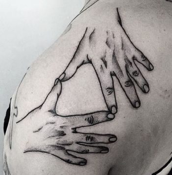 Hands tattoo on the shoulder