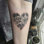 Heart shaped flower tattoo on the arm