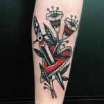 Heart stabbed with dagger and flowers tattoo