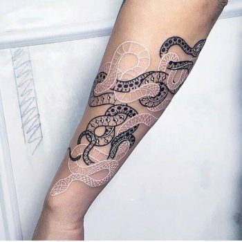 Intertwined black and white snake tattoo