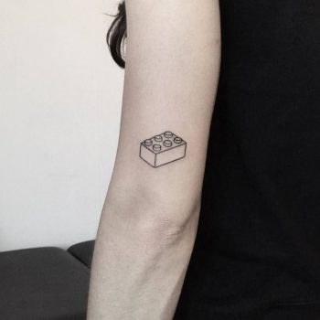 Lego brick tattoo on the left arm