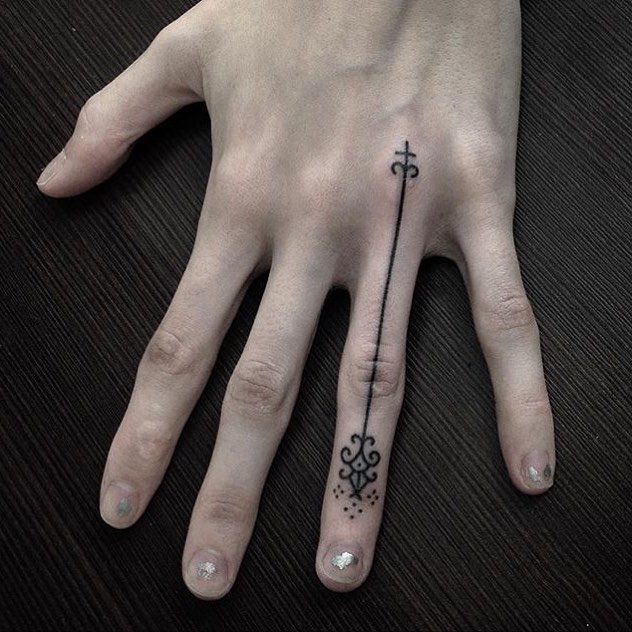 Long stylized arrow tattoo