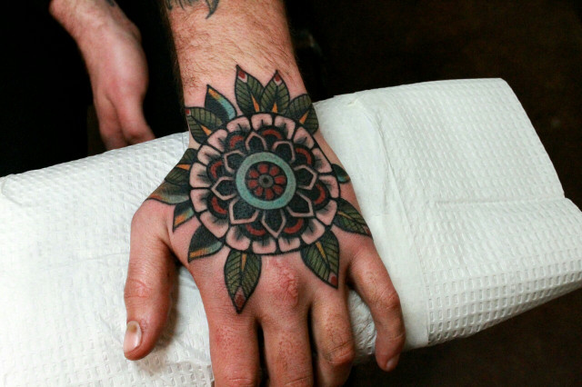 Lovely mandala tattoo on the hand